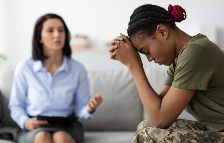 Posttraumatic stress disorder. Depressed black soldier woman attending therapy session with